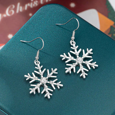 Silver-plated snowflake dangle earrings with rhinestones.